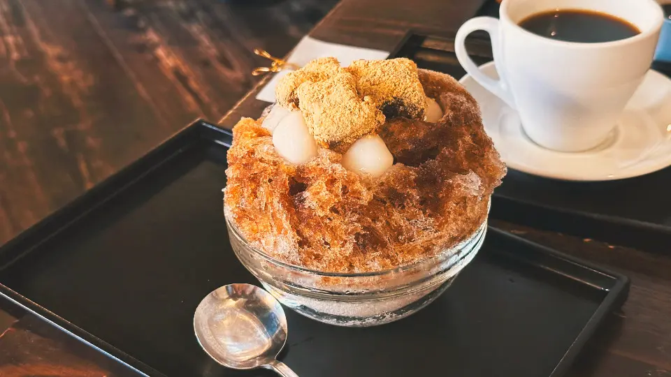 Umezonos Brown Sugar Shiratama Warabi Mochi Kakigōri – fluffiges Kakigōri (japanisches Shave Ice) mit reichhaltigem Sirup aus braunem Zucker, getoppt mit weichen Reisbällchen und zartem Warabi Mochi